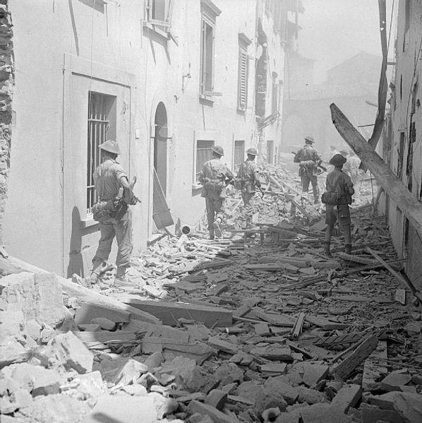 Allied forces in WWII. Soldiers walking in rubble.